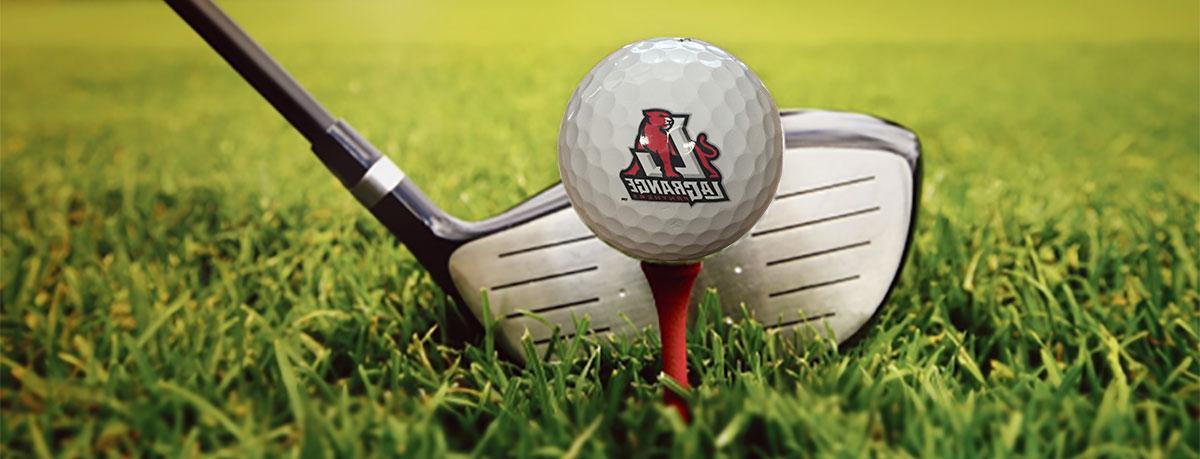 A LaGrange Panthers golf ball on a red tee  with a golf club